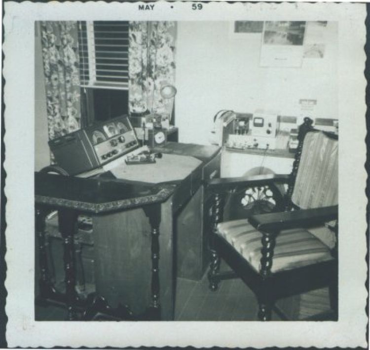 In early 1959 I moved the shack to my upstairs bedroom, and the J-38 key has been replaced by a Johnson Speed-X bug (on the desk in front of the receiver). The 6AG7 10-watt transmitter is on a bookcase to the right of the SX-99, and I'm using my second homebrew transmitter, a 6146 75-watt rig from the 1958 Radio Amateur's Handbook; it's just to the right of the chair.
