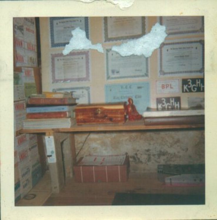 The outside basement wall, beneath the window; Official Relay Station, Official Bulletin Station, Code Proficiency with a 30wpm sticker, Brass Pounders' League... There's a Latin textbook on top of those two Radio Amateur's Handbooks!