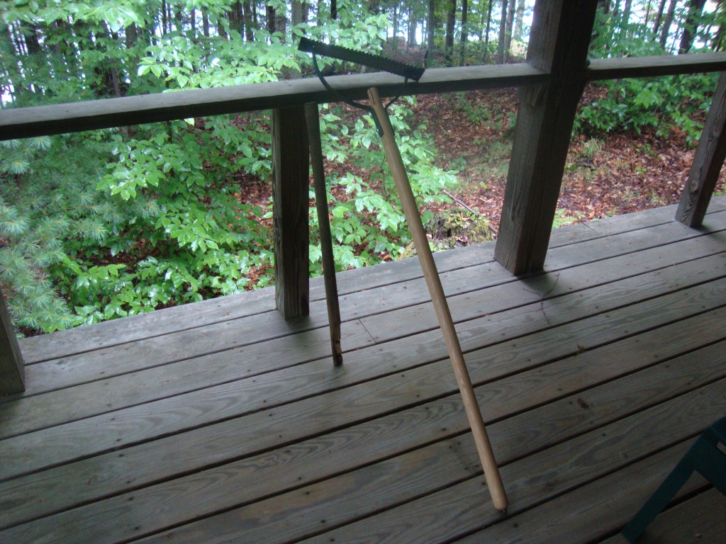 John is proud of his new sickle/scythe handle! The old one is shown too... it broke.