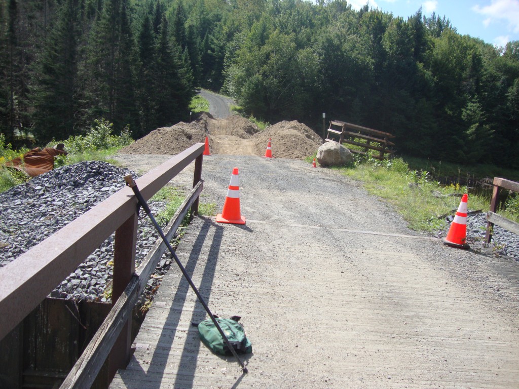 This shot looks back, south, to the location of the previous photo. The big new culvert, to be installed within a few days, is waiting in the dark area to the right.