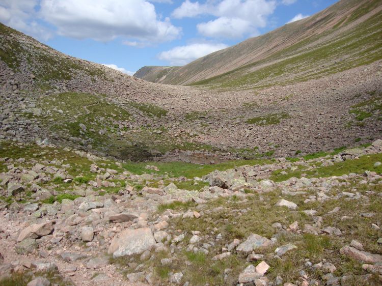 At 1:12 PM the path (vaguely apparent as an S shape left and above center) crossed another rock slide. Though not steep, they required caution to avoid twisted ankles, and the continuation of the path was sometimes hard to find. 