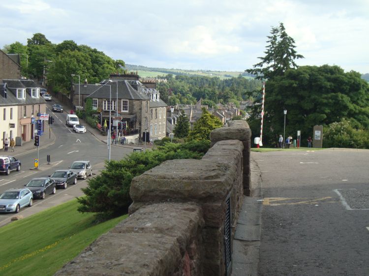 A last Inverness shot, before my trip's next phase, Monday June 20 (Day 25 of the trip), to show how close Inverness Student Hotel is to the Great Glen Way's terminus. The monument is ahead, at the right; the hostel is uphill, the white building barely visible in trees just  behind the fifth vehicle! 