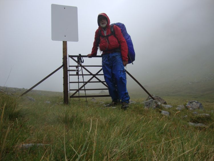 By 3:30 PM I had ascended (in moderate rain) to this pass, ready to descend along a stream called Allt Cairnean to the level of the River Pean and Loch Arkaig. This metal gate once had fences at each end. I don't know what they separated. 
