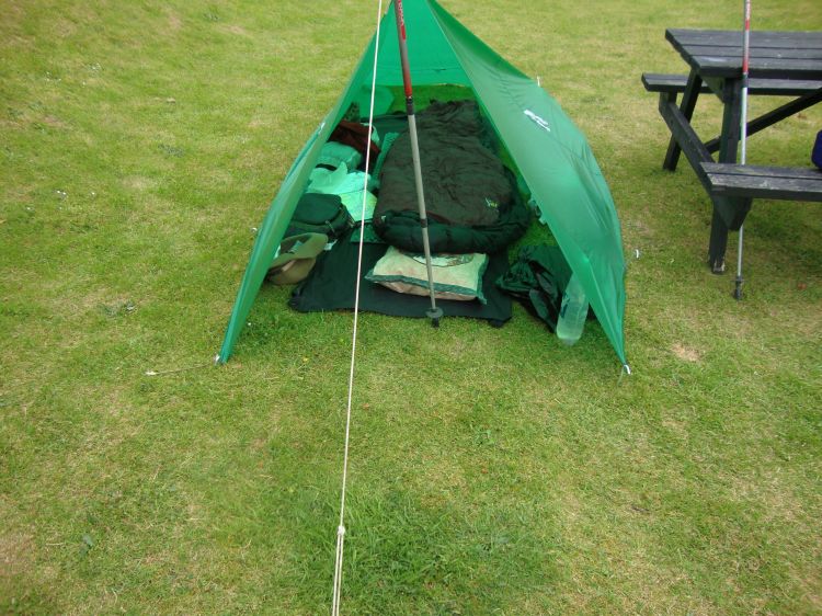 Wind was puffing my tarp out a bit, but this 6:40 PM photo gives an idea of my camp. The hat holds watch, audio recorder, headlamp, and notebook; behind it, the pack's top flap pocket has my passport and currency, GPS, monocular, and other important items. Dry, warm, comfortable, and easy to set up!