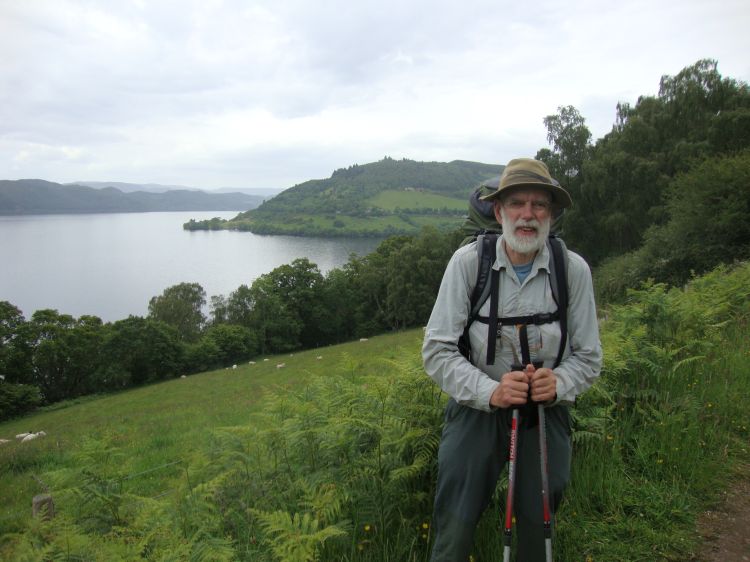By 10:00 AM we'd left and risen above the busy, narrow A82. A fellow hiker snapped this, looking south (over some sheep) toward Drumnadrochit. Urquhart Castle is barely visible on that point. 