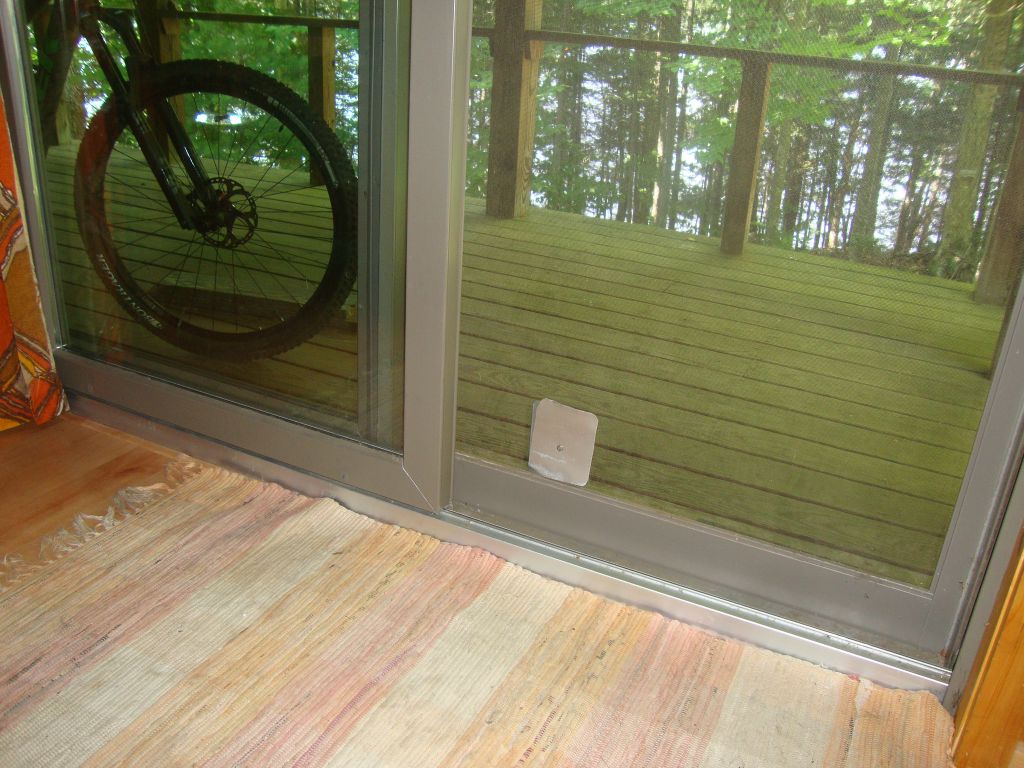 Squirrel patch, crude but effective
My seed attracted no birds but plenty of chipmunks and squirrels. Twice a squirrel got in through that fiberglass screen (one spent a night behind the stove), perhaps with some cat's-claw help. I removed the seed feeders and patched the hole with this aluminum. 