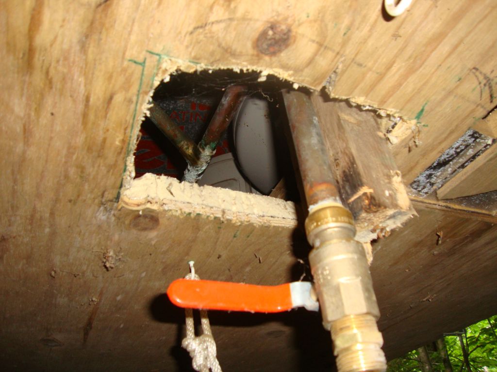 The lake valve
We're looking up into the doghouse, past the now-closed lake valve. It must be opened to drain the system fully, and closed for system use. The heating devices are "upstairs" in the doghouse; this valve will be protected by the insulated "cathouse" and the valve warmed through this opening from the doghouse heaters.