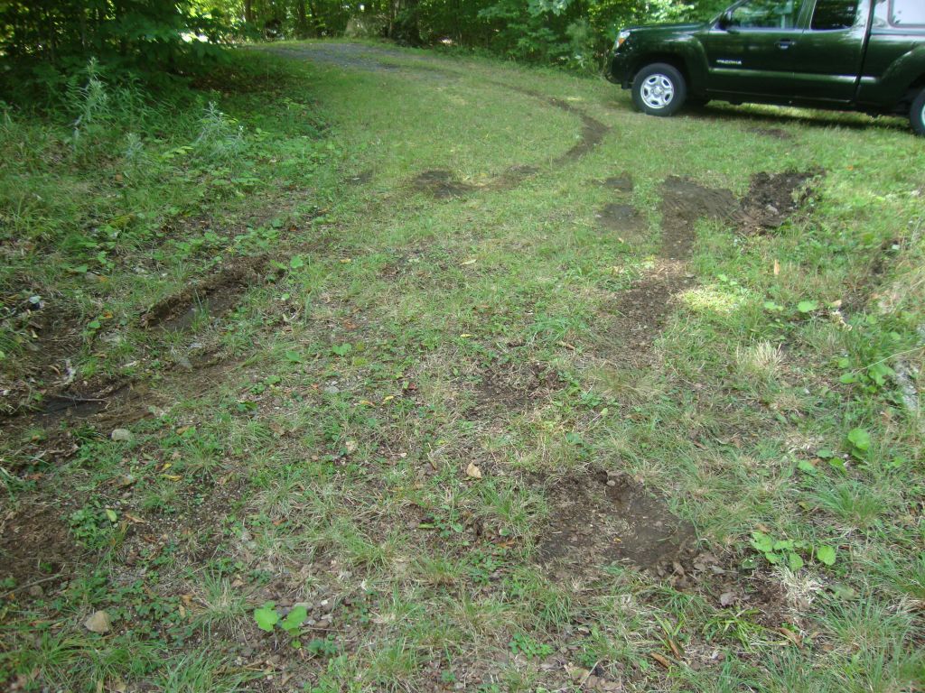 Delivery truck damage
The FedEx or UPS driver had driven down onto my sub-driveway and could not find traction on the soft wet grass trying to back up. I was able to get the Tacoma past her, connect my yellow tow line, and provide enough pull to get her up onto the main driveway.