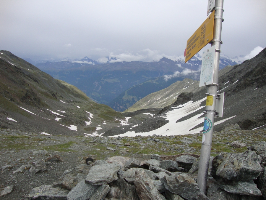 It was nearly 5:00 PM when I finally reached the 2895m Augstbord Pass. I was too exhausted and concerned (about getting back down) to set up a self-photo with the tripod. This view looks ahead. Gruben is down there somewhere; I have a hotel reservation there!