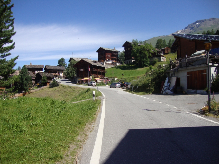 The trail from Col du Tsate is that street coming in from the right; the yellow trail signs are just out of view. L'Ecureiul is the first brown building, so --- unlike my frustrating St. Niklaus fumbling --- I found lodging right away!